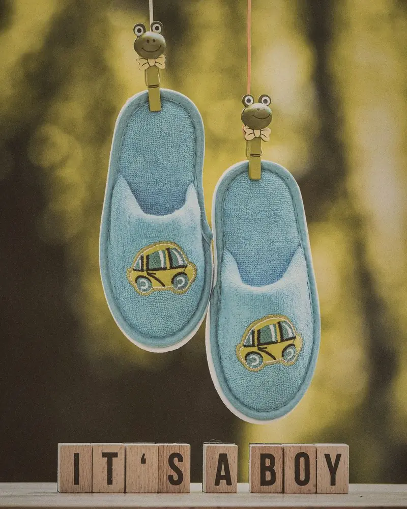 Petits chaussons de bébé suspendus au-dessus de cubes en bois